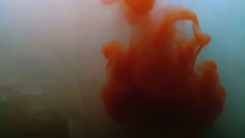 Medium shot of abstract colorful red paint slowly mixing in water Stock Footage 147313898