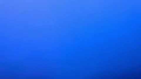 Medium shot of abstract red paint slowly dissolves in water on blue background Stock Footage 147314017