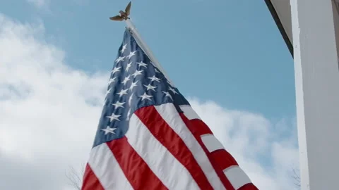 Medium Shot of the American Flag Waving in the Wind in Front of Lens Stock Footage 133019137