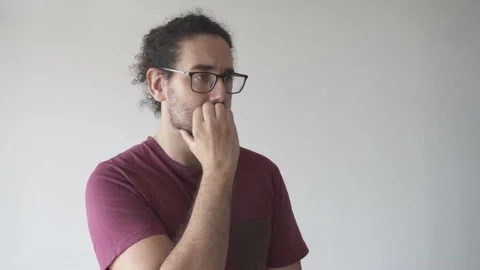 Medium shot of anxious young man biting his nails Stock Footage 161551821