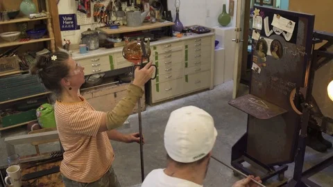 Medium shot of artisans shaping molten glass 스톡 동영상 76227107