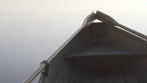 Medium shot of the back end of a rowboat on a lake in Finland Stock Footage 113962607