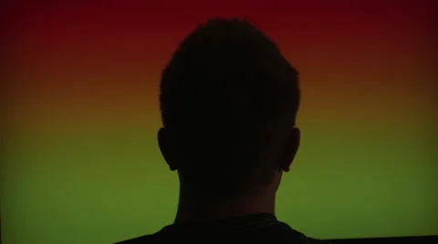 Medium Shot of Back of Man's Head, Staring at Screen with Rapidly Flashing Co 動画素材 68723649