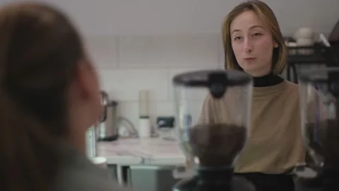 Medium shot of barista communicates with a visitor Stock Footage 232203444