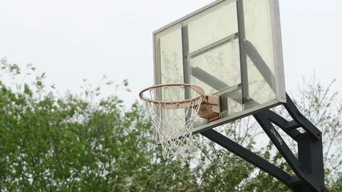 Medium shot of a basketball going in the hoop Stock Footage 128643866