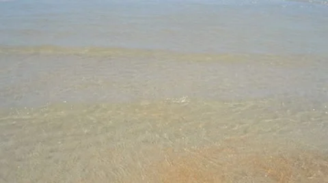 Medium shot of beach with man walking into view Stock Footage 8960700