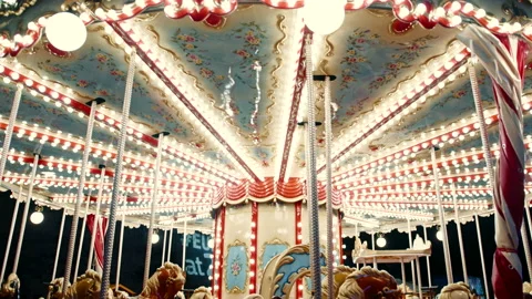 Medium shot of a beautiful old-fashioned spinning carousel attraction for kids w Stock-Footage 186288374