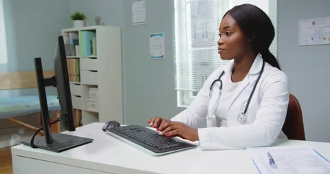 Medium shot of beautiful young african american woman doctor assistant working Stock Footage 147257985