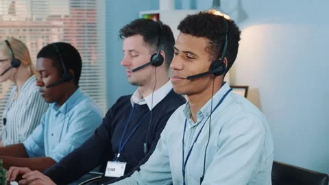 Medium shot of black call center agent feeling exhausted and broken-down after Video stock 130660073