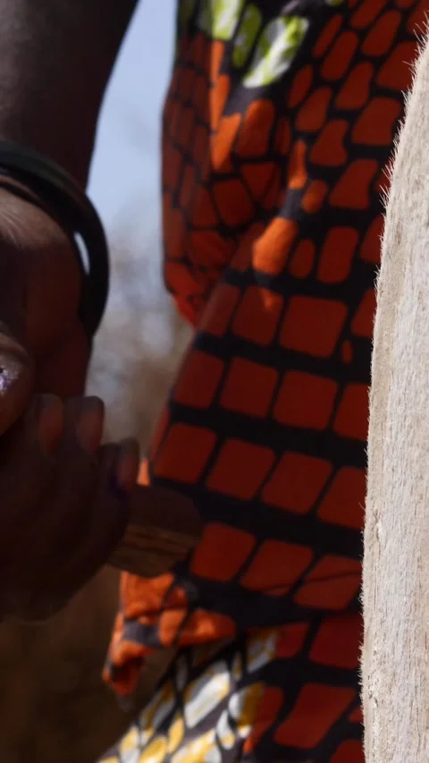 Medium shot of black man hand hitting skin of dundun with wooden stick Stock Footage 228843057