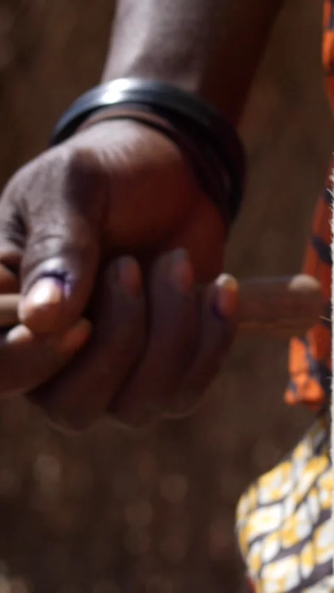 Medium shot of black man hand hitting skin of dundun with wooden stick Stock Footage 230663594