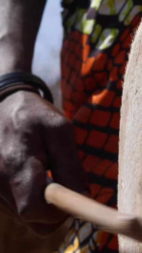 Medium shot of black man hand hitting skin of dundun with wooden stick Stock Footage 230663667