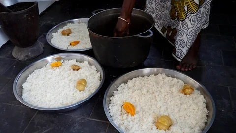 Medium shot of black woman adding fish to 3 big bowls of rice Video stock 116260035