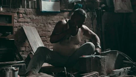 Medium shot of a blacksmith working in a smithy workshop Stock Footage 142789772