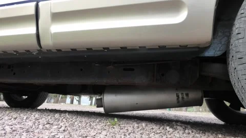 A Medium Shot of a Broken Exhaust Pipe and Muffler Stock Footage 299730425