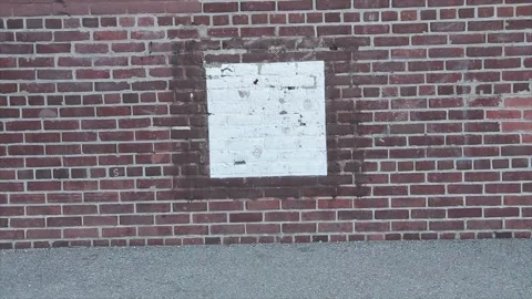 Medium shot of burby baseball square strike zone square on a brick wall Stock Footage 246137319