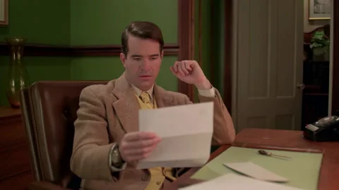 Medium shot of a businessman reads a document, 1960s, USA - Reenactment Stock Footage 245290557