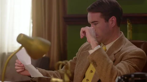 Medium shot of a businessman reads a document, 1960s, USA - Reenactment Stock Footage 245290568