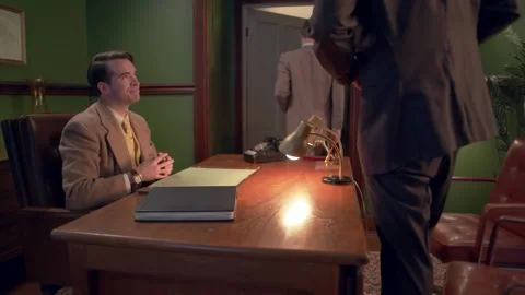 Medium shot of a businessman shaking hands, 1960s, USA - Reenactment Stock Footage 245290566