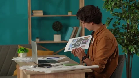 Medium shot capturing a man working in his home office, getting a videocall Stock Footage 260066180