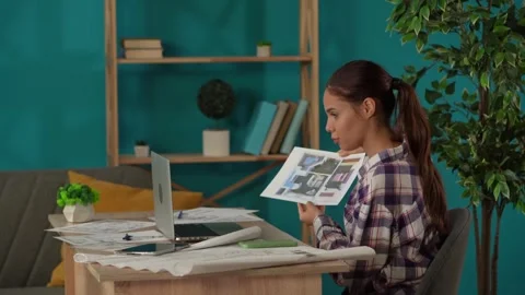 Medium shot capturing a woman working in her home office, getting a videocall Stock Footage 260065643
