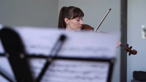 Medium Shot Caucasian female practicing from home, having a fun Playing a violin Stock Footage 155108170