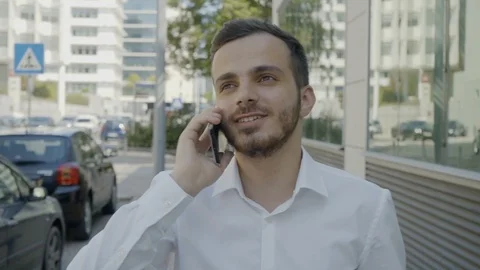 Medium shot of Caucasian manager talking on phone with smile Stock Footage 97918780