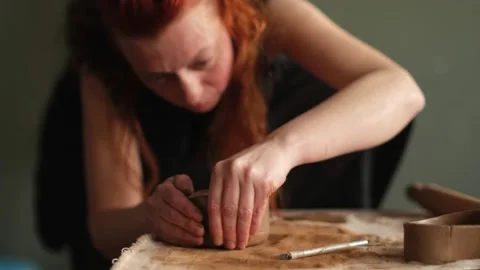 Medium shot of ceramic artist sculpting a bowl with clay in the studio Stock Footage 236328958