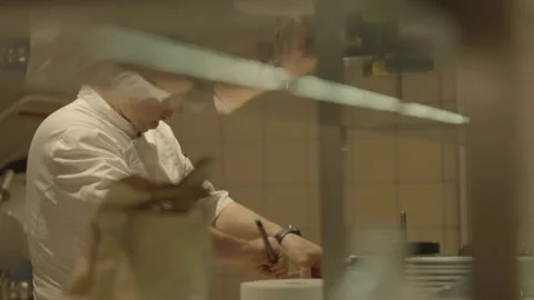 Medium shot chef scraping dish with spatula 動画素材 336173883