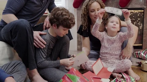 Medium shot of children looking at their gifts at Christmas 動画素材 73035545