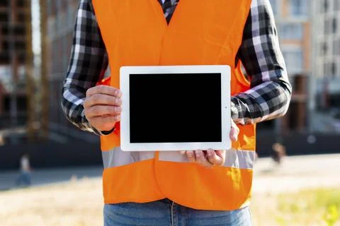 Medium shot construction engineer holding tablet Stock Photos