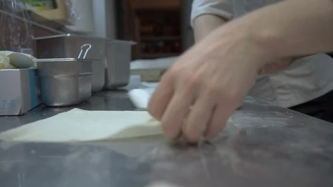 Medium shot of cooks rolling springrolls Stock Footage 102336082