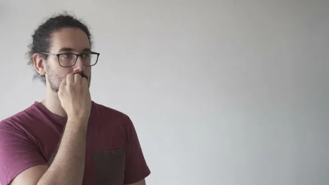 Medium shot with copy space of distracted man biting his nails looking away Stock Footage 161551896