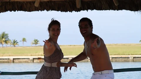 Medium shot, Couple dancing salsa on pier, silhouetted Stock Footage 38761833