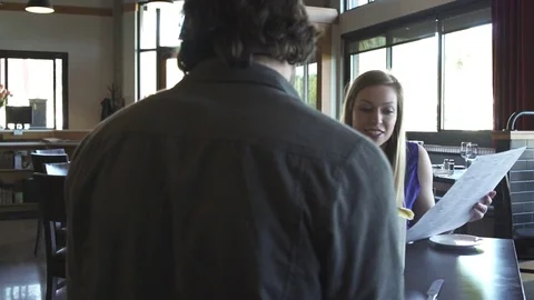 Medium shot of a couple reading menu in a restaurant Stock-Footage 76235068