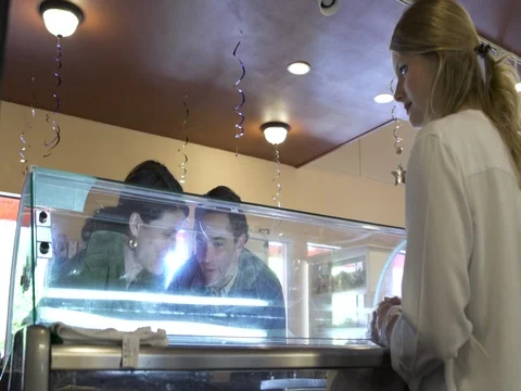 Medium shot of a couple tasting ice cream in a pastry shop 動画素材 76567657