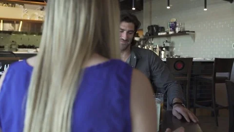 Medium shot of a couple toasting in a restaurant Stock-Footage 76234676