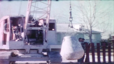 Medium shot, crane machine lifts up a wrecking ball  to smash the ground. Vídeo Stock 126056316
