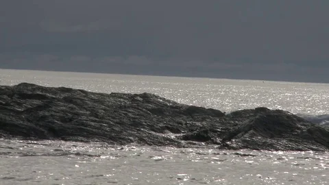 Medium shot of crashing waves on rocks Stock Footage 75240509