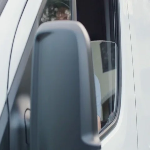 Medium Shot Of A Delivery Man Opening Window of his Cargo Van and Smiling at the Stock Footage