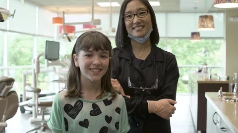 Medium shot of a dentist and her patient Stock Footage 76217343