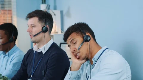 Medium shot of Dissatisfied multiethnic call center agent talking to the client Stock Footage 124252122