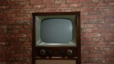 Medium shot dolly in to tv set vintage Stock Footage 100612541