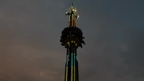 Medium Shot of Drop Zone Amusment Park Ride during Sunset Stock Footage 92762533