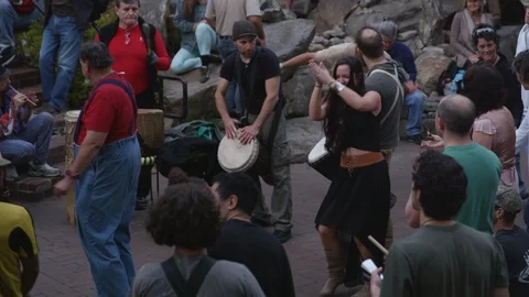 Medium shot of drummers perform during the live concert and people dance around Video stock 103432652
