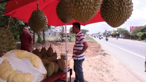 Medium shot of durian fruit stand by highway in Vietnam Stock Footage 61064116