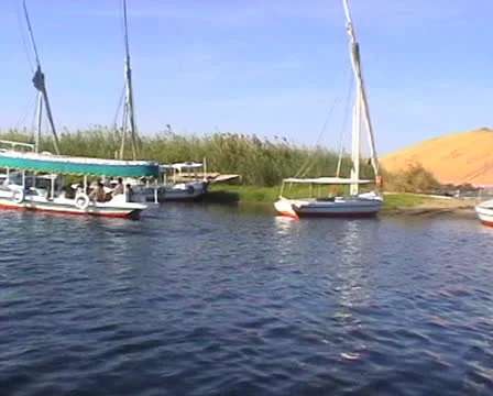 Medium shot of an egyptian gulet with passengers on the Nile Stock Footage 22672701
