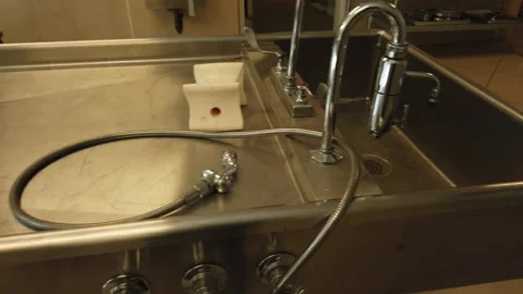 Medium shot of empty morgue gurney, sink and tray of scissors Stock Footage 143507762