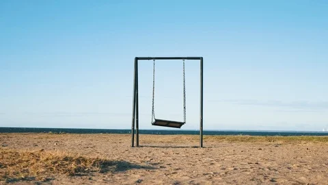 Medium shot of empty seesaw swing by the sea Stock Footage 126933791