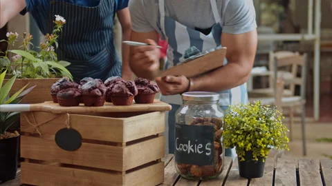 Medium shot of exited and new small business owners taking stock take in their m Stock Footage 199633347